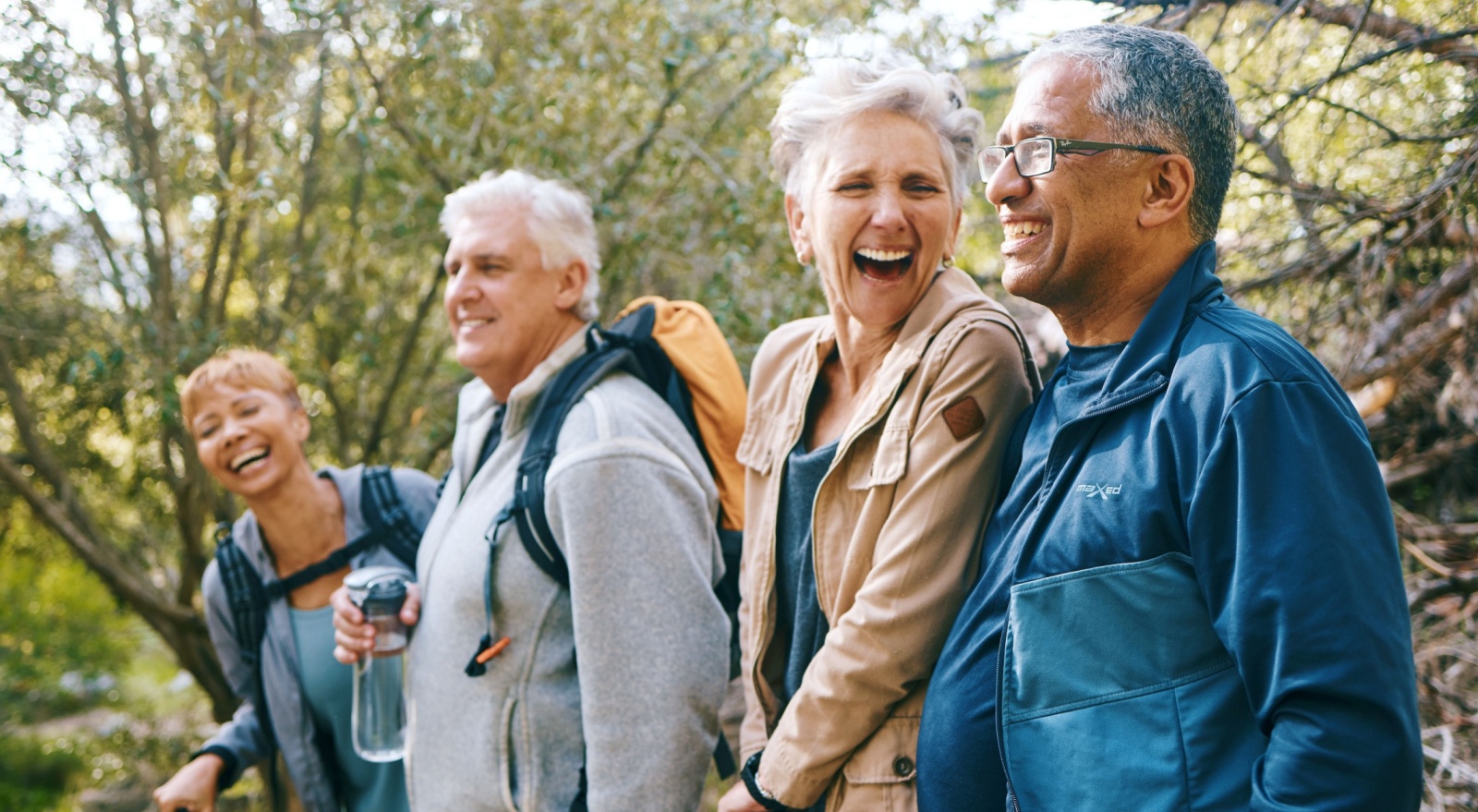 A group of friends hiking and laughing together.