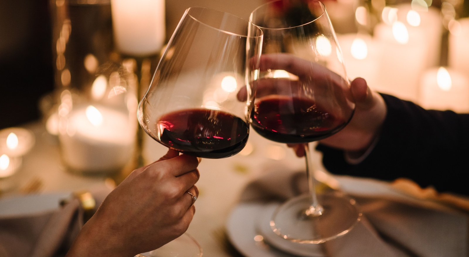 A couple toasting with a glass of wine.