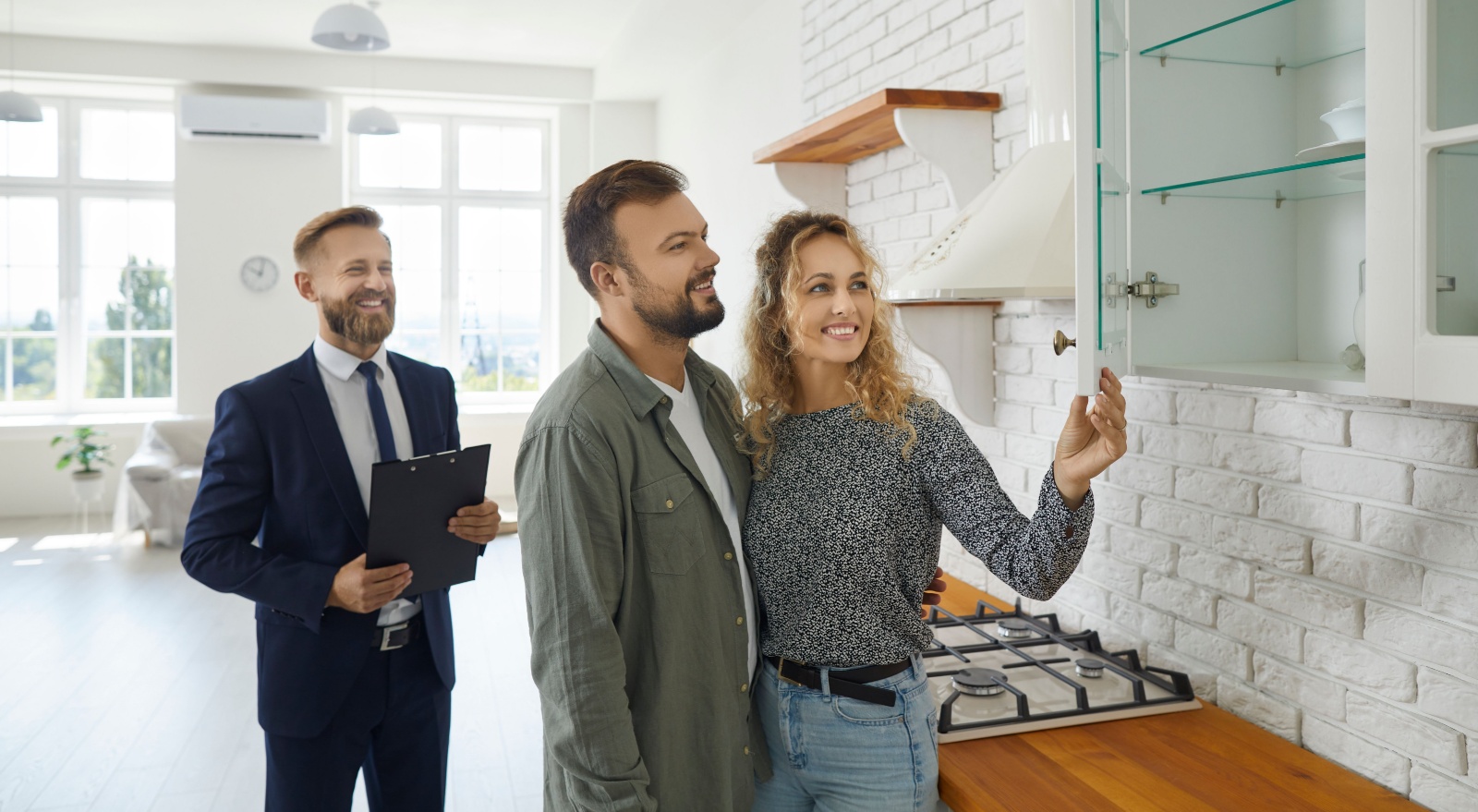 A couple viewing a property with an estate agent.