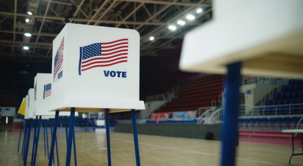 A voting booth with an American flag.