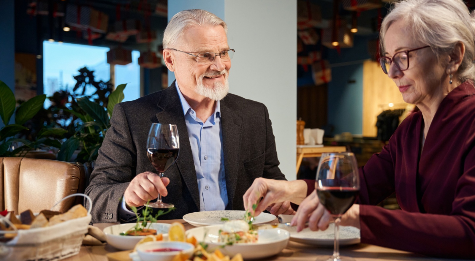 A couple enjoying a meal in a restaurant together.
