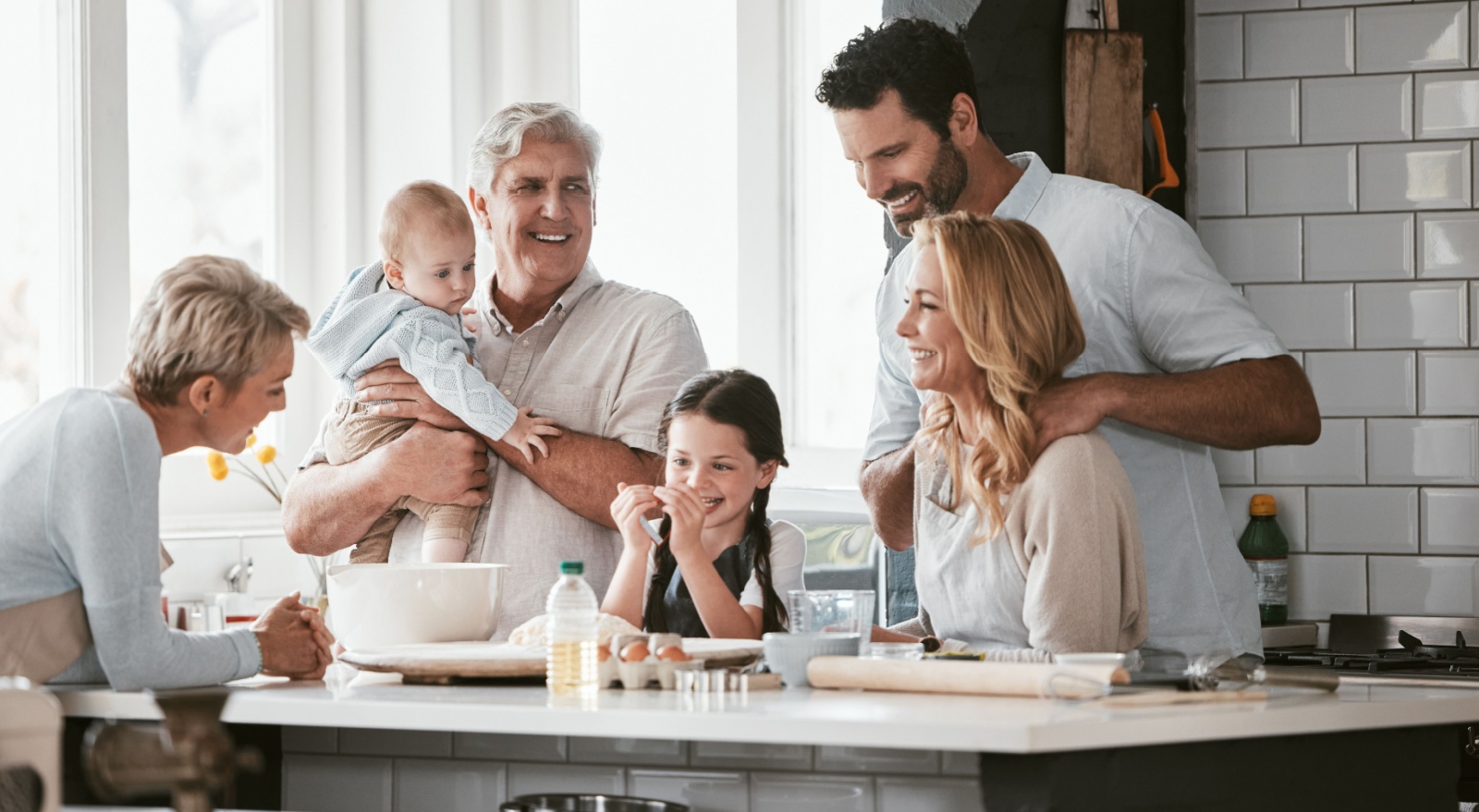 Three generations of family cooking in the kitchen