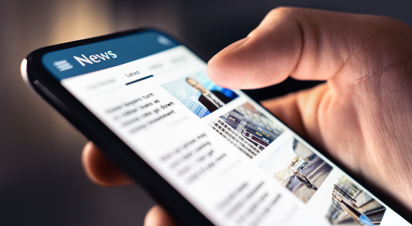 A person looking at a news feed on their phone.