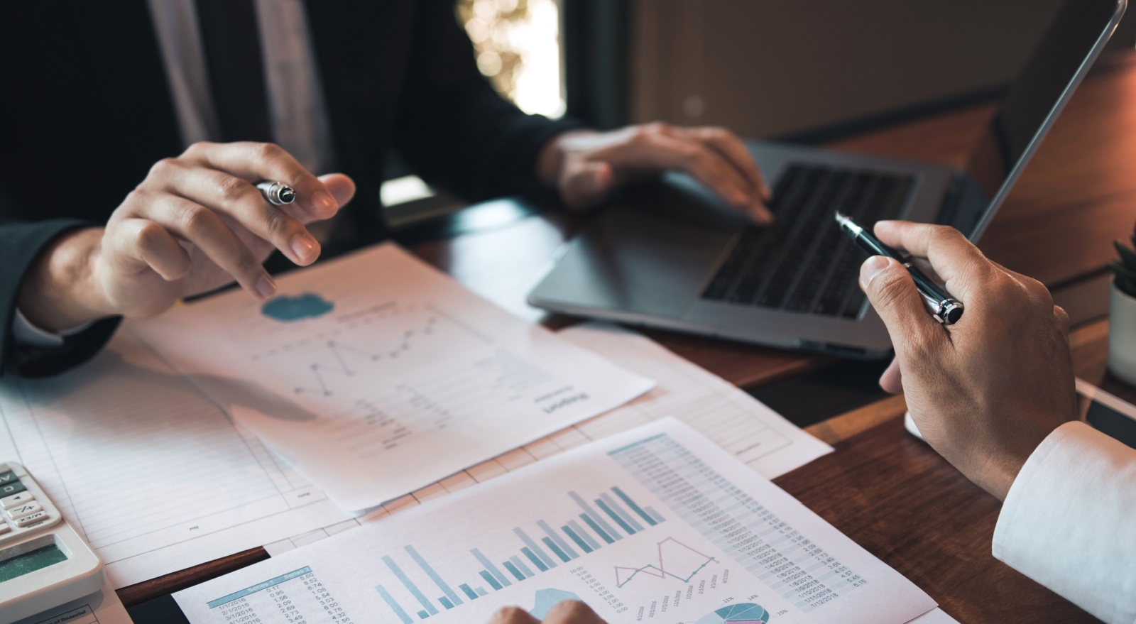 Two people analysing statistical reports.