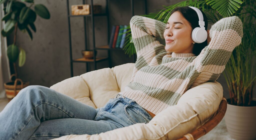 A woman relaxing with headphones on.