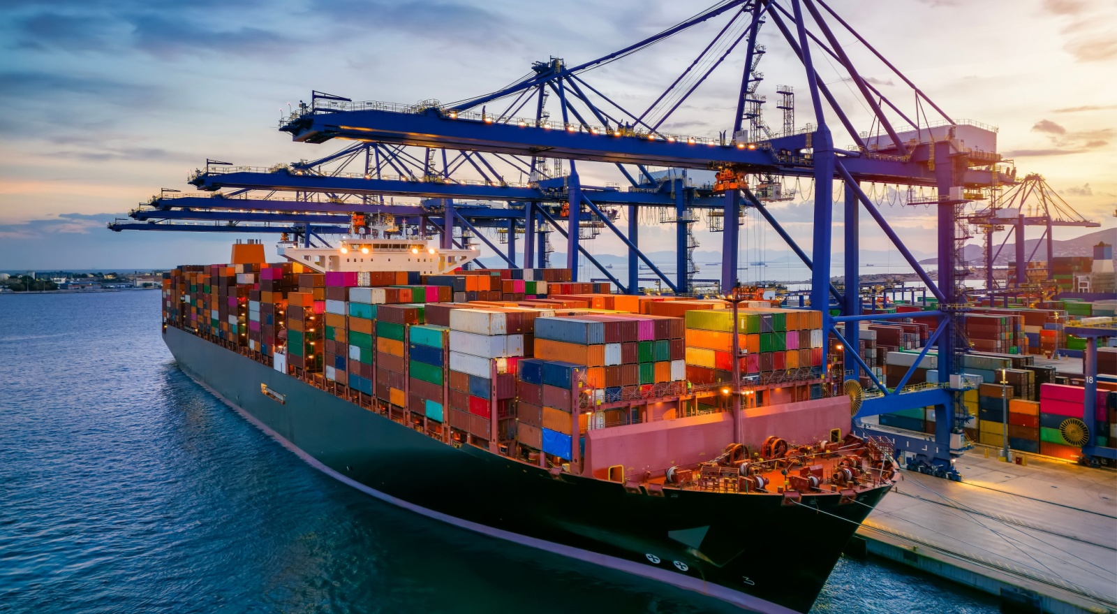 A container cargo ship at a commercial dock.