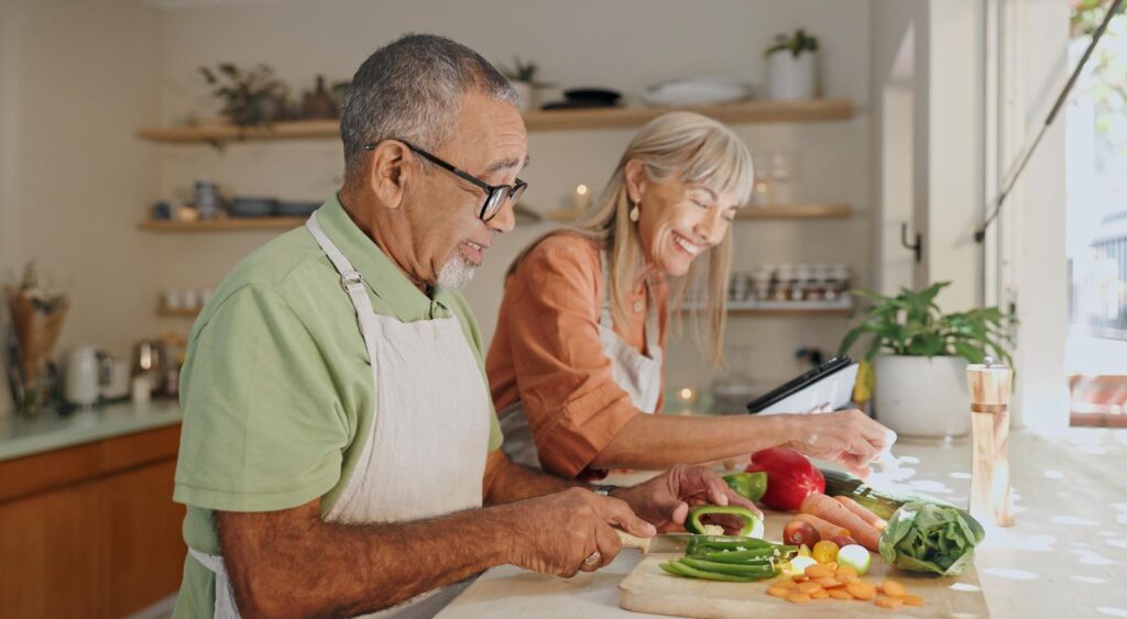A couple cooking a meal together.