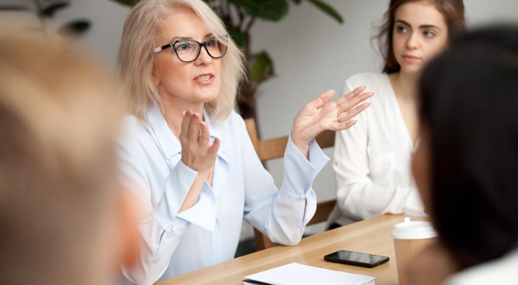 A woman talking during a work meeting.