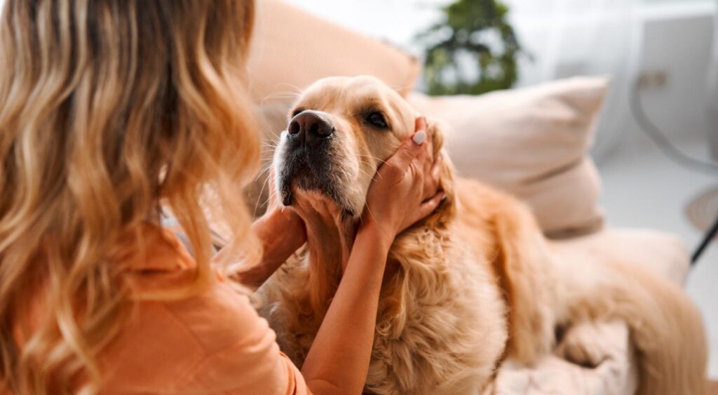 A woman and her dog at home.