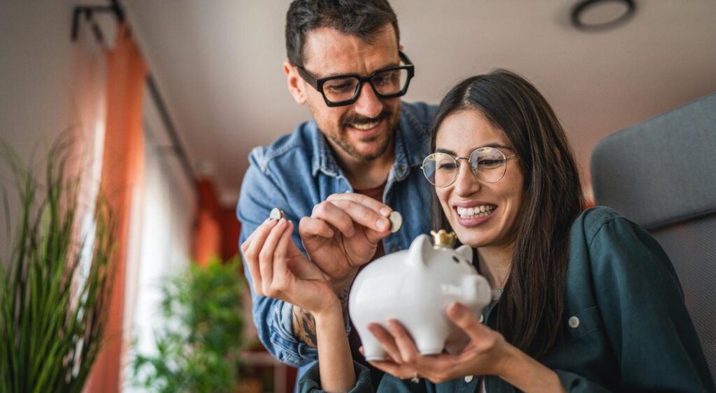 A couple saving in a piggy bank.