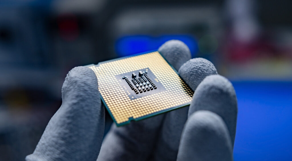 A hand holding a CPU.