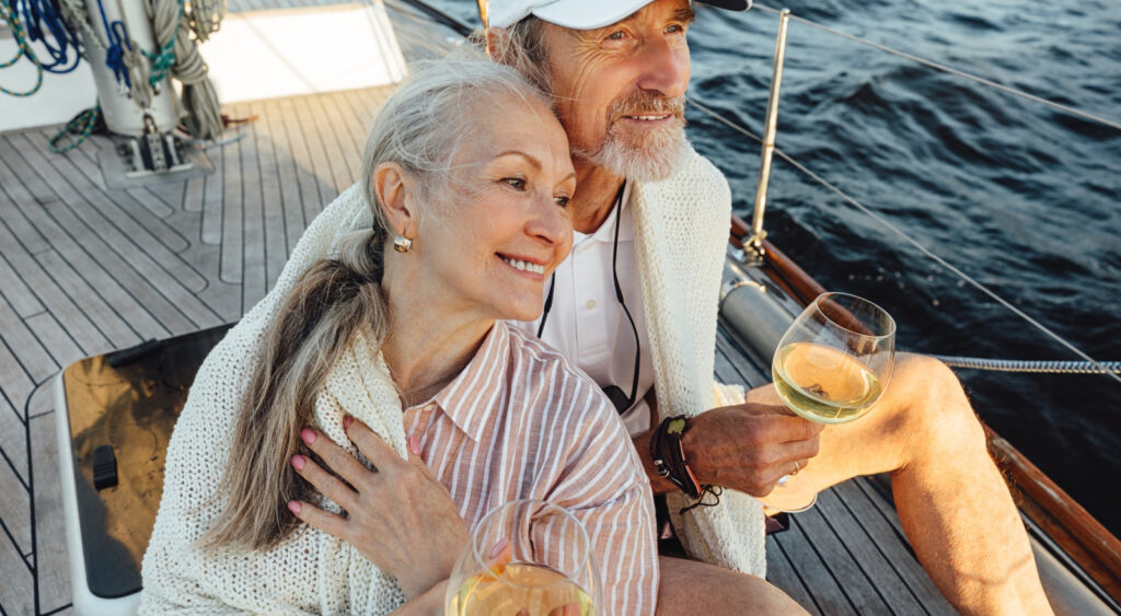 A couple sitting on a yacht deck.
