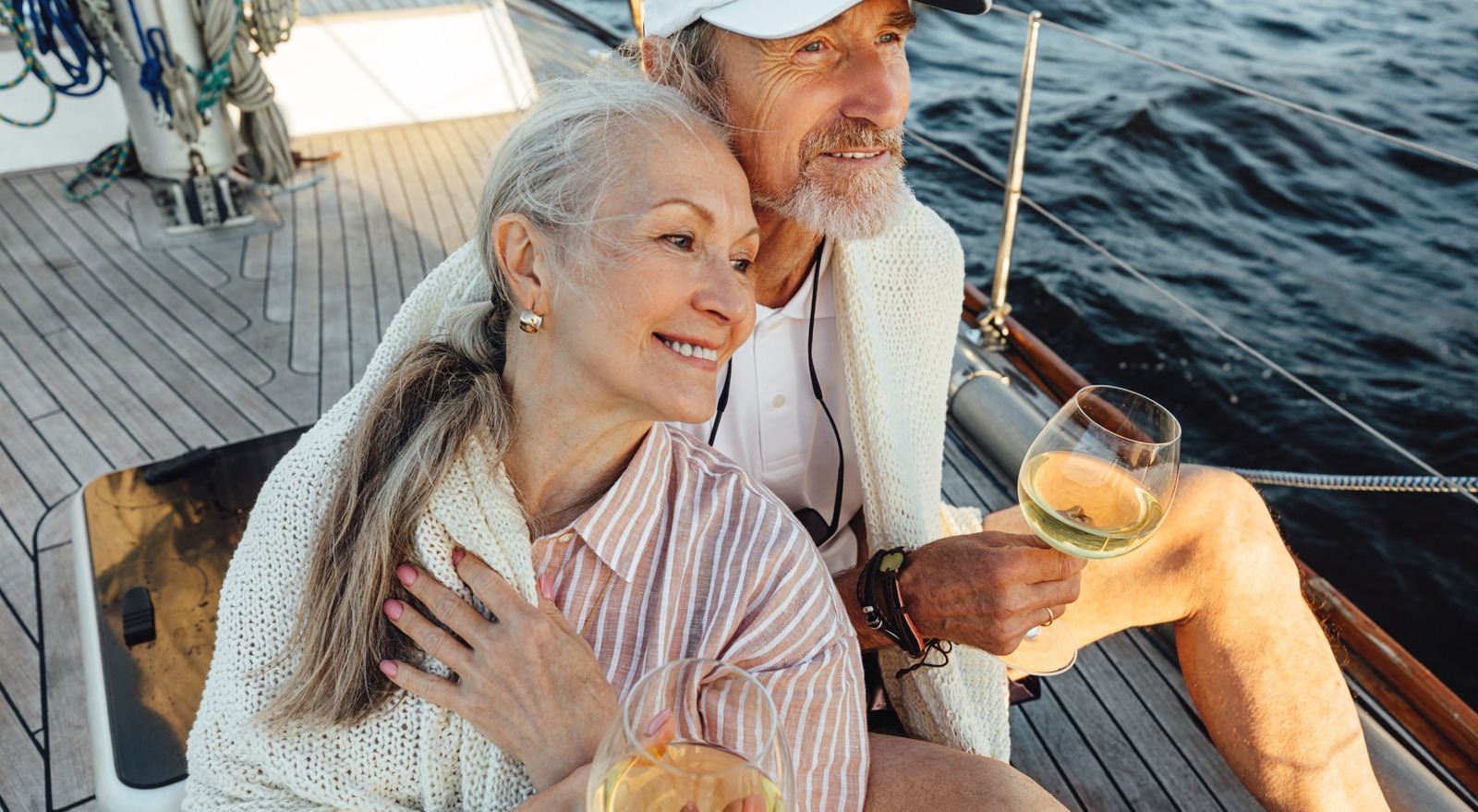 A couple sitting on a yacht deck.