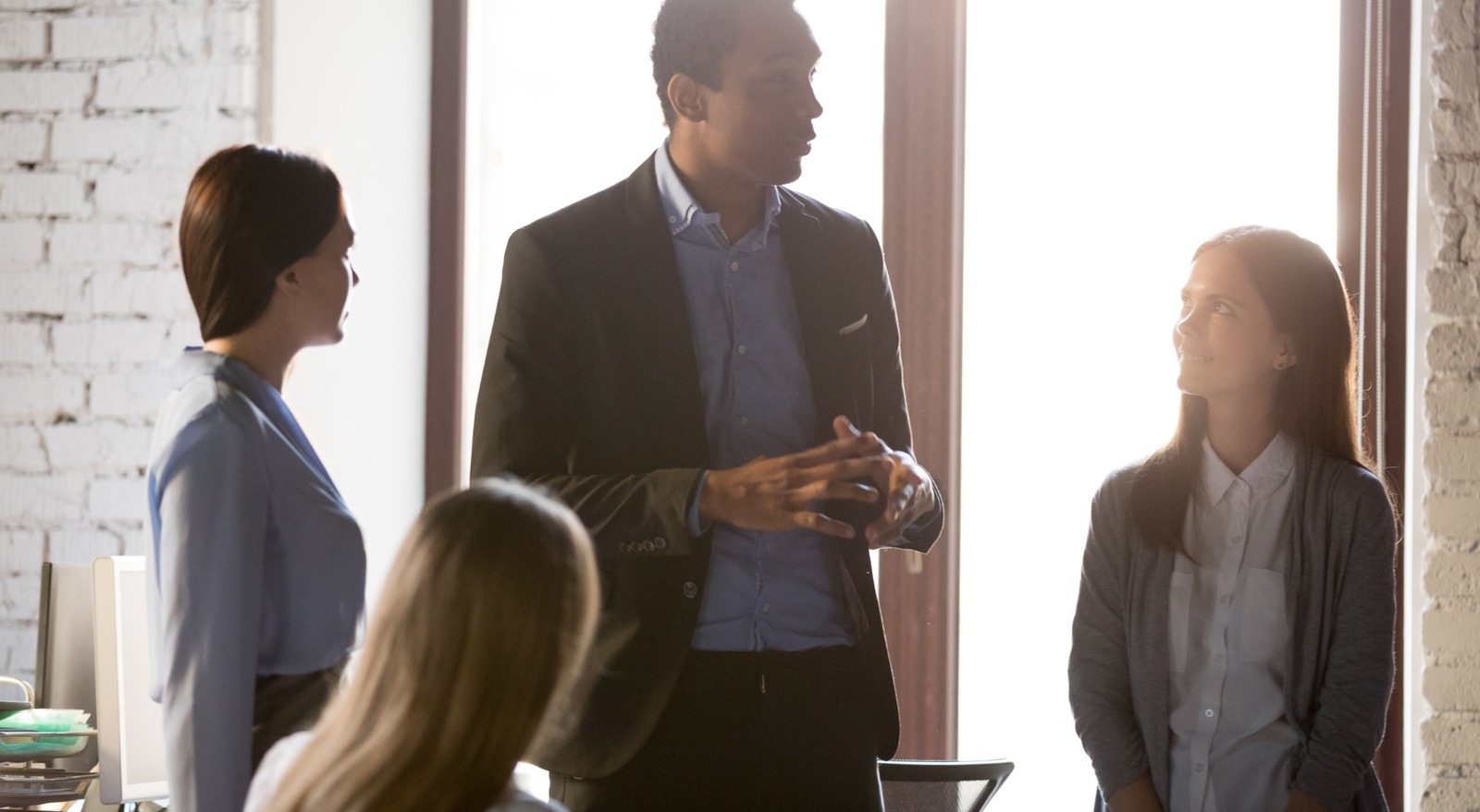 A business owner speaking with his employees.