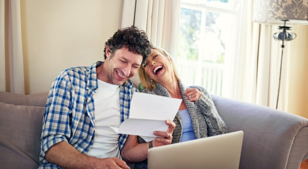 A happy couple reviewing paperwork.