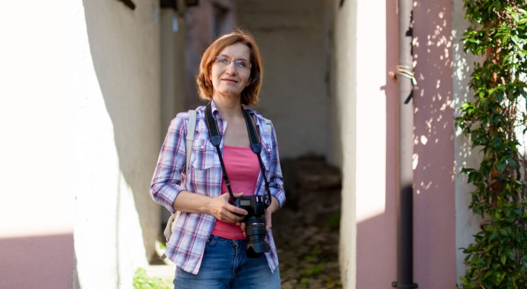 Woman on an urban street holding a camera