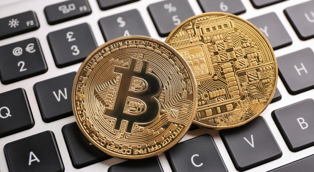 Depiction of physical bitcoins on a keyboard.