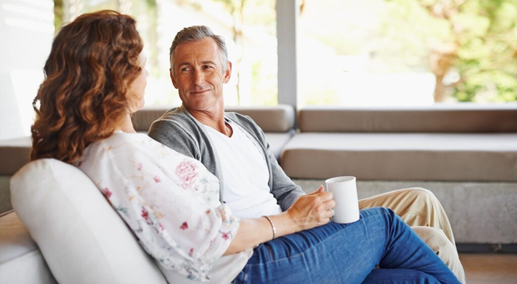 A couple talking in their home.