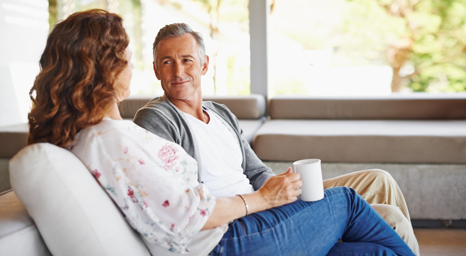 A couple talking in their home.