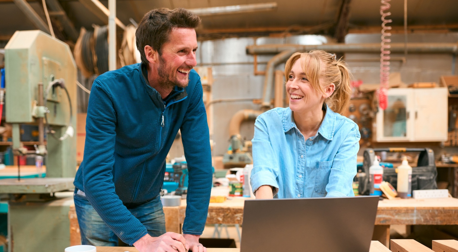 Two people in a woodwork workshop.