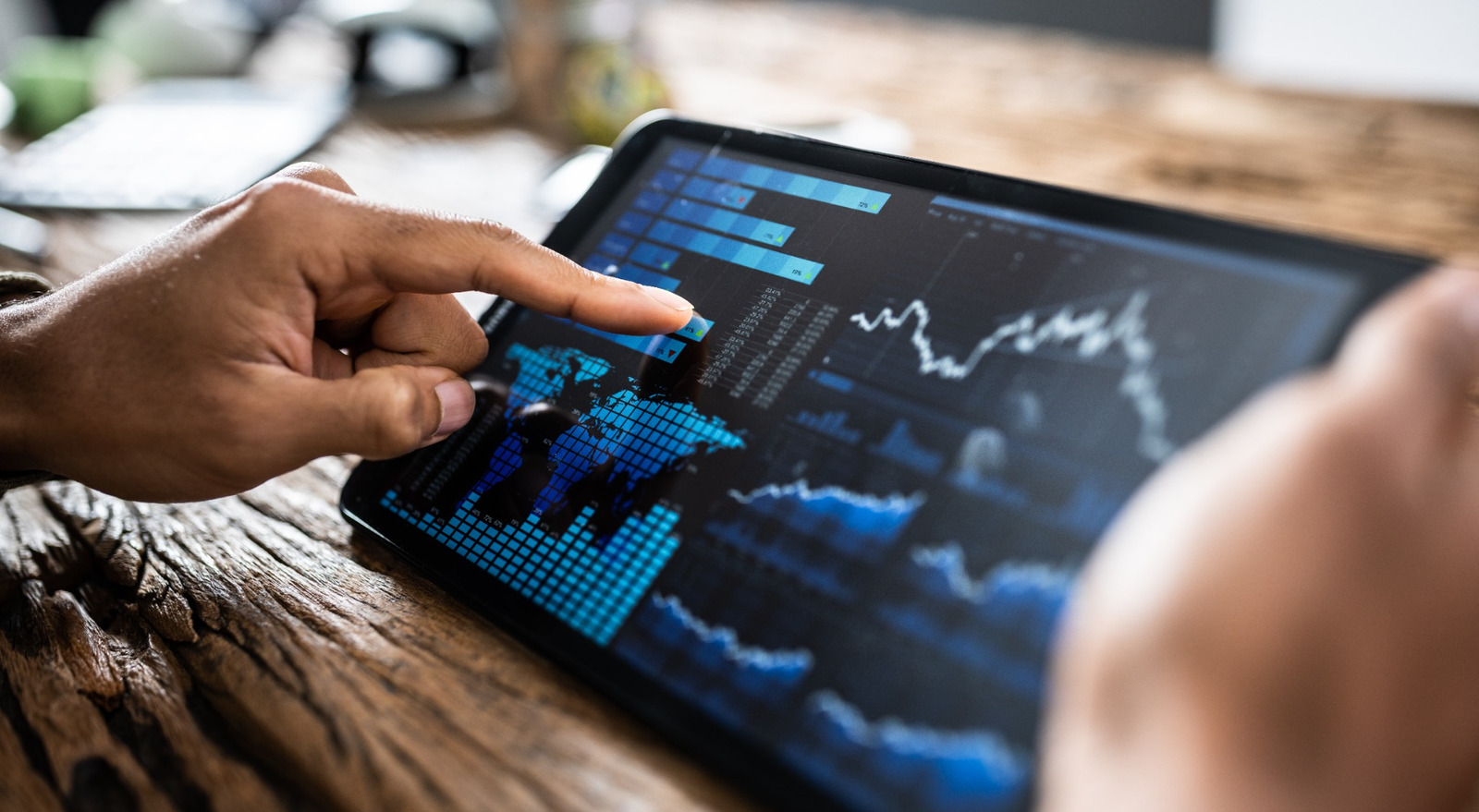 A person reviewing investment performance on a tablet.